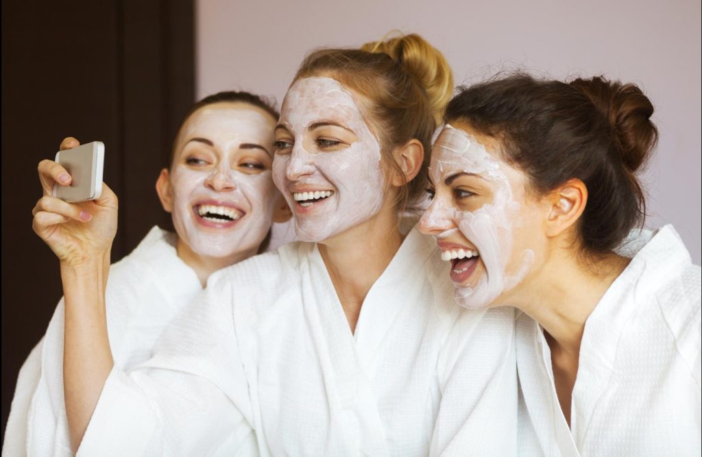 three-young-happy-women-face-masks